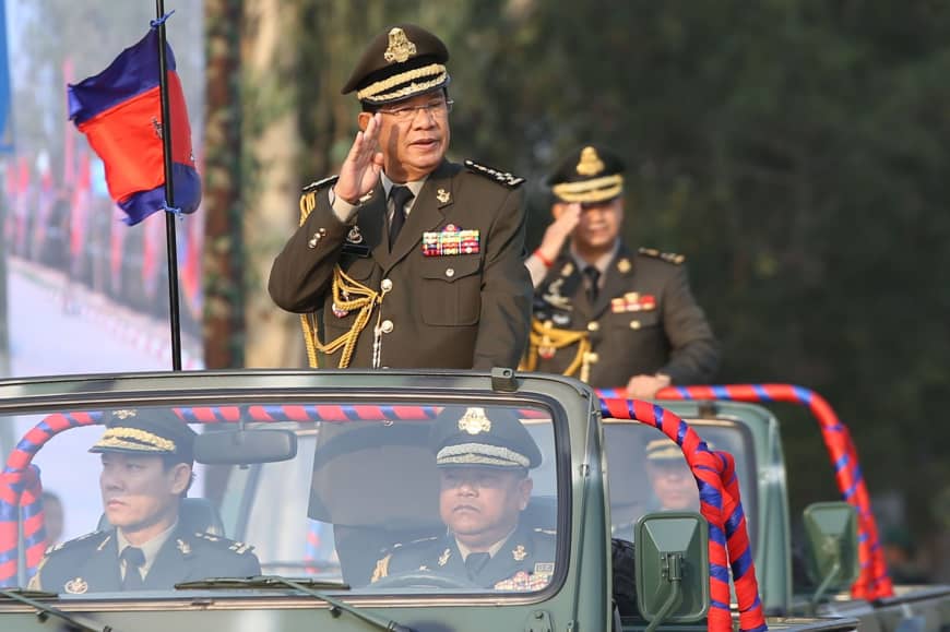  Cambodian Prime Minister Hun Sen salutes accompanied by his son, Commander of Cambodian Infantry Army Lt. Gern. Hun Manet (right) during an inspection of troops at a ceremony marking the 20th anniversay of the formation of Cambodian Infantry Army in Phnom Penh on Thursday. Hun Sen issued an ominous vow to 