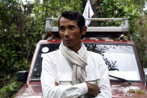   This handout photo taken in 2011 and released by the Cambodian Center for Human Rights shows Chhut Vuthy, president of the Natural Resource Conservation Group, standing in front of his car in Cambodia. The prominent Cambodian activist was fatally shot in a remote forest Thursday while documenting illegal logging in a clash that also killed a military police officer, authorities said.  